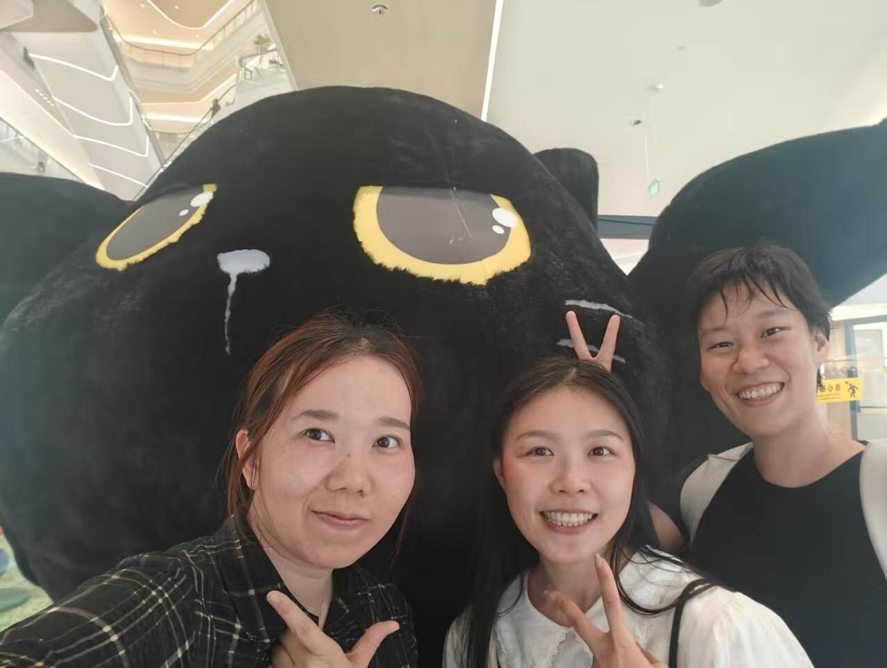 Cherish Judy and dididi with a large black cat display