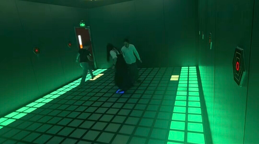 Cherish Judy and dididi playing in a glowing grid escape room