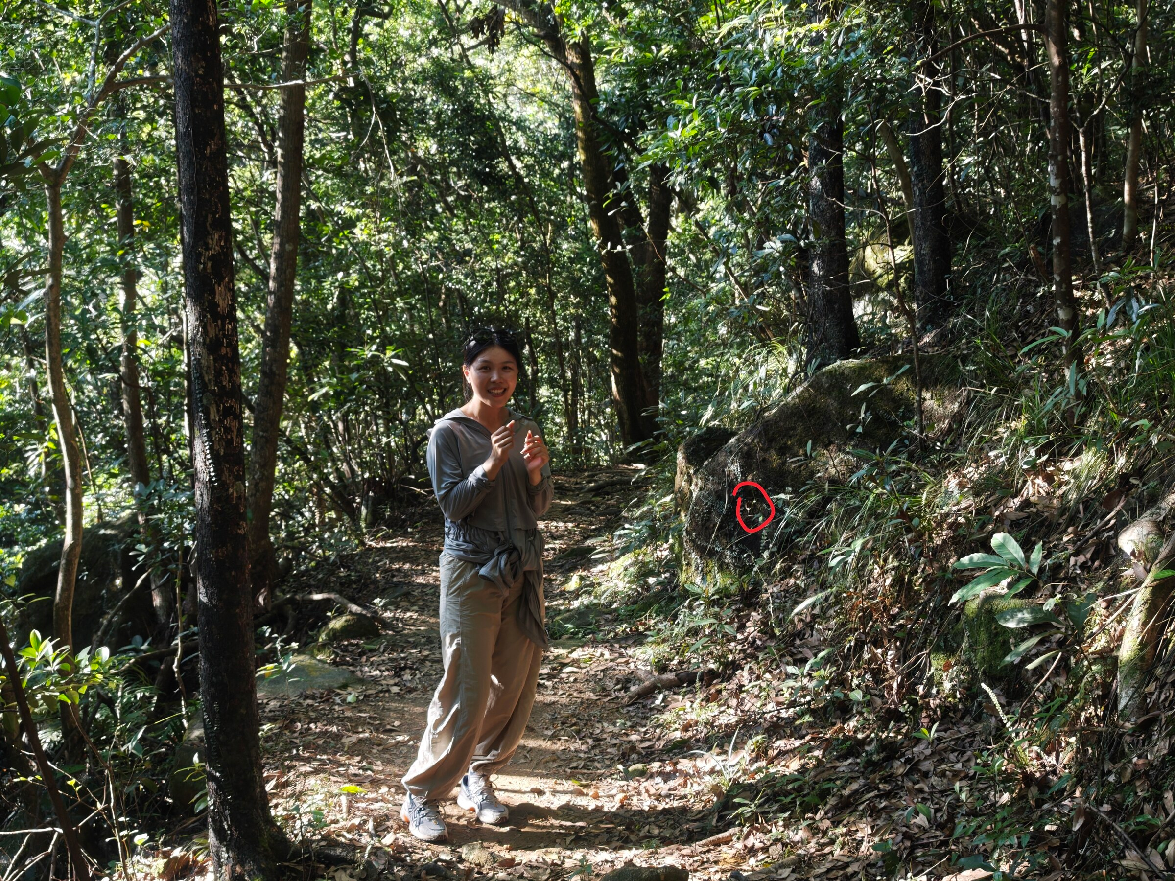 Judy on the Tai Po Kau trail with a firefly marked nearby